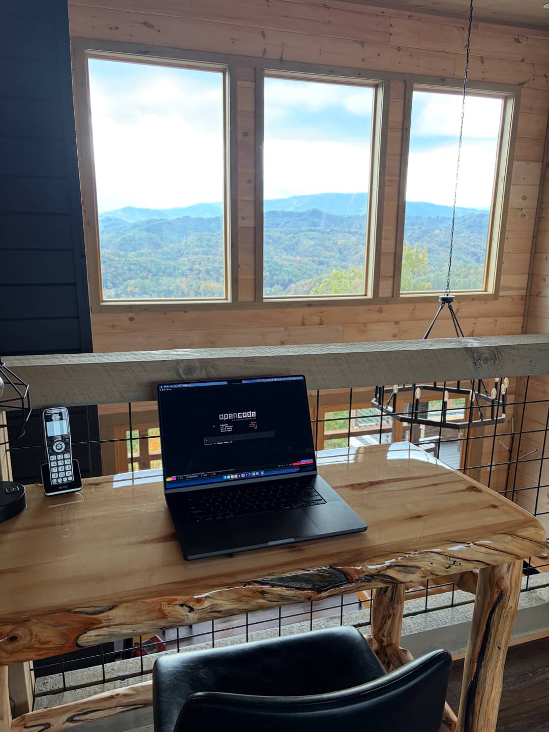 Developer working with AI tools in a scenic mountain environment